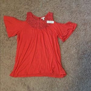A charming Charlie’s off the shoulder shirt